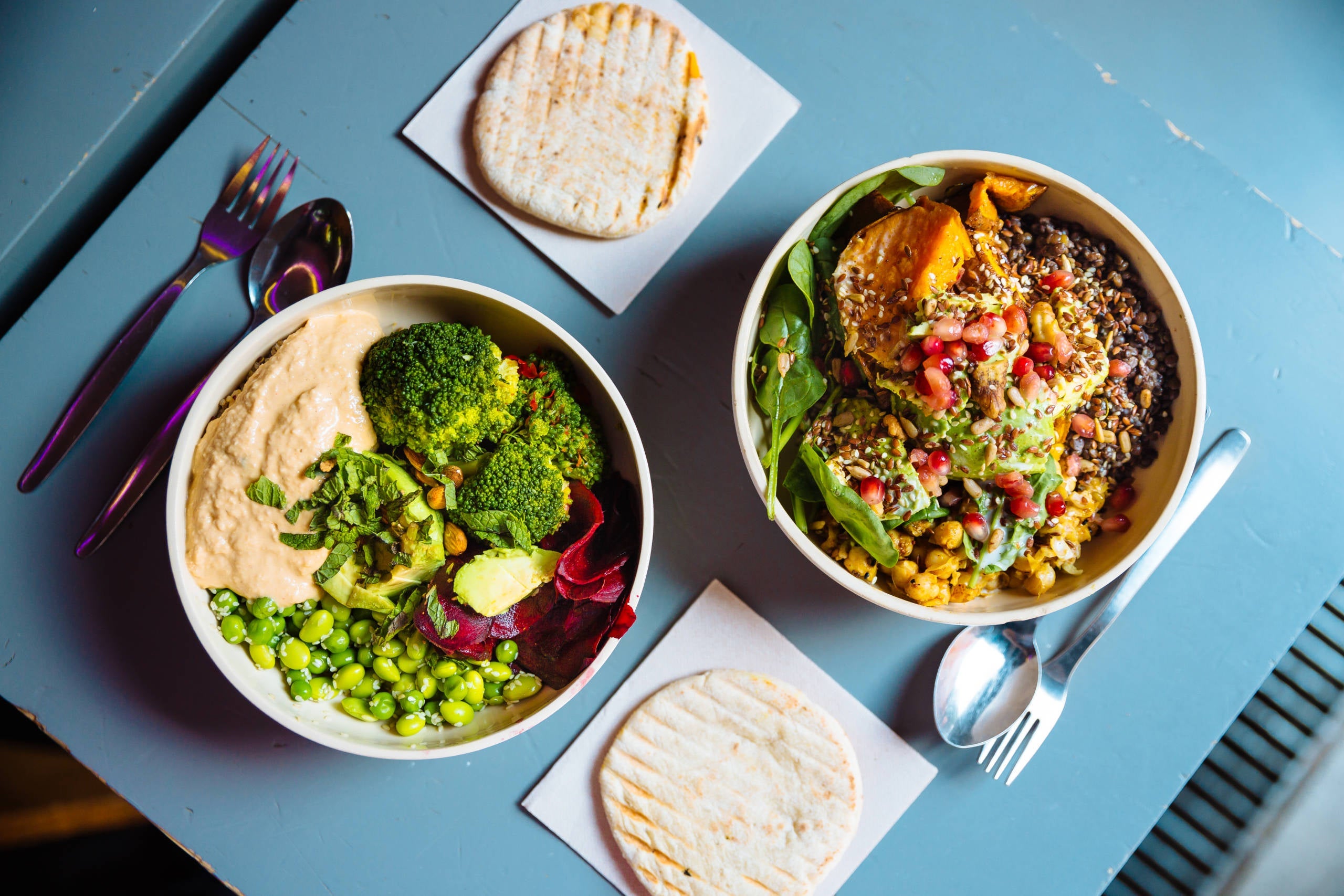 Vegan bowls with various vegetables and seeds, high angle view
