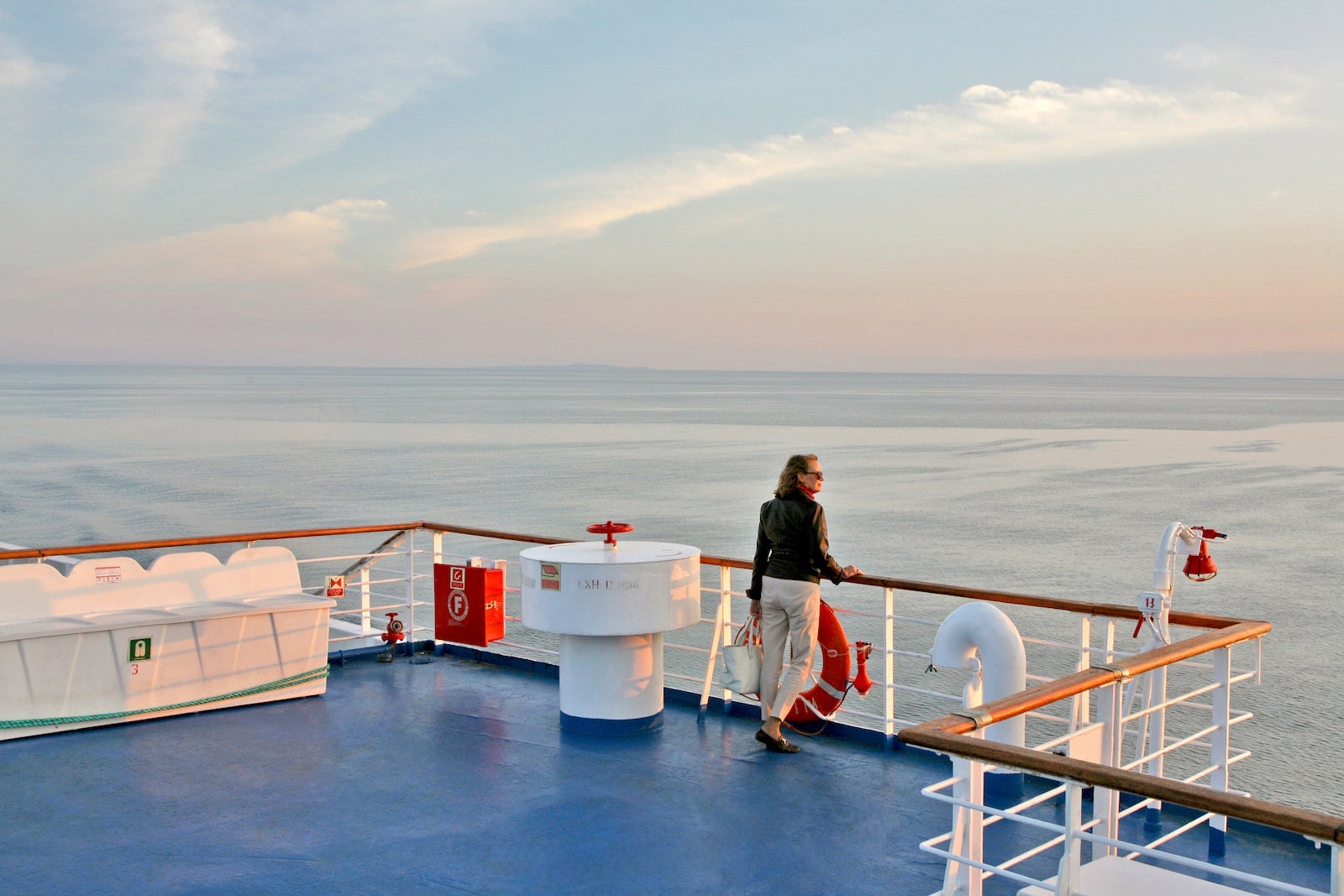 Woman on cruise boat looking out to sea