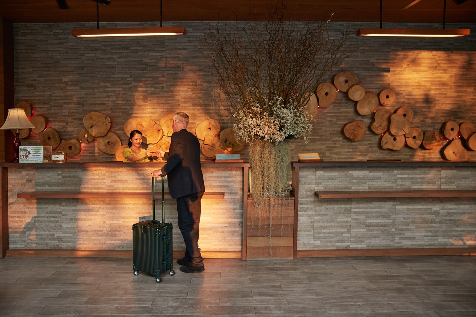 Man giving passport to receptionist in lobby