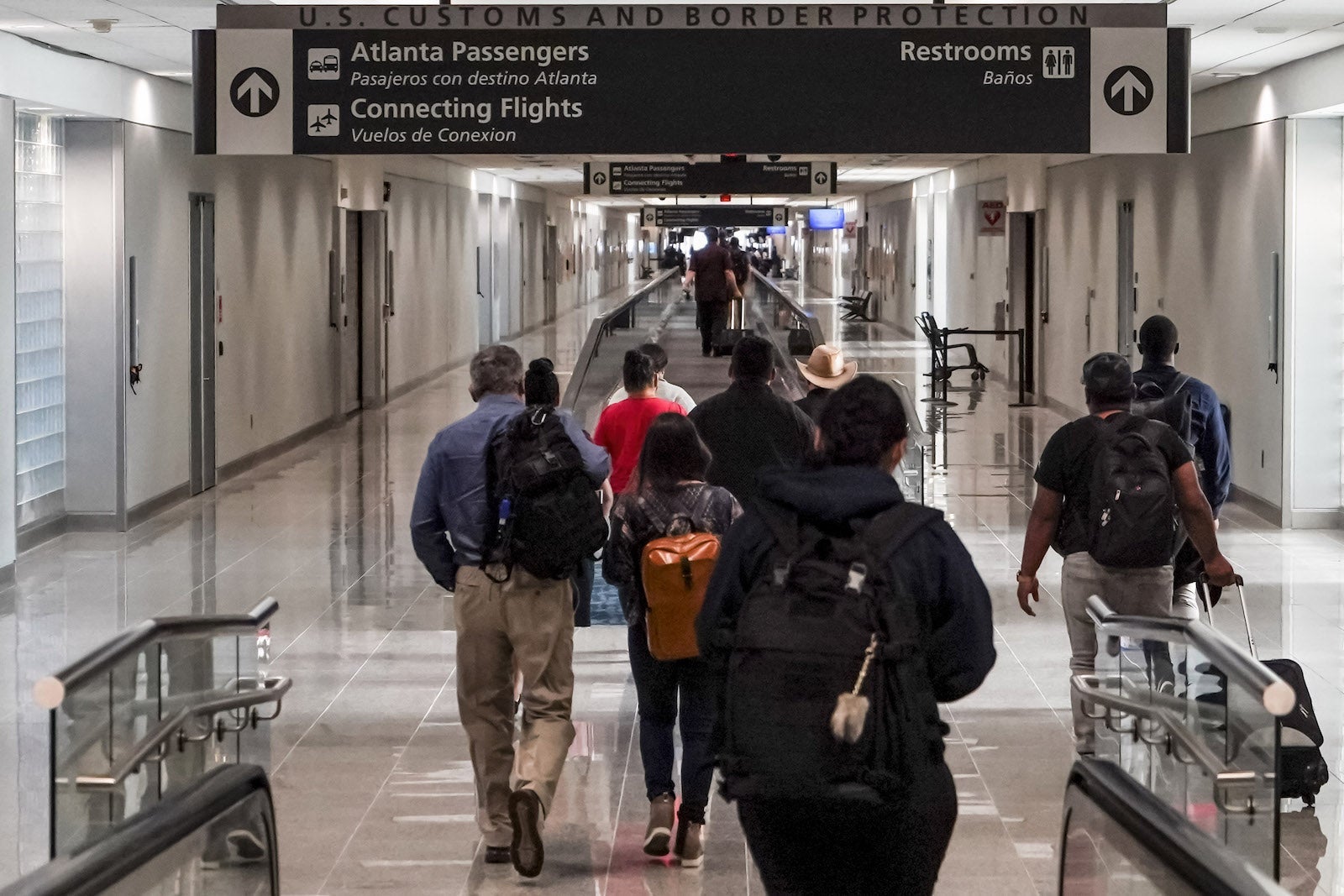 Travelers walk into US customs at Hartsfield-Jackson