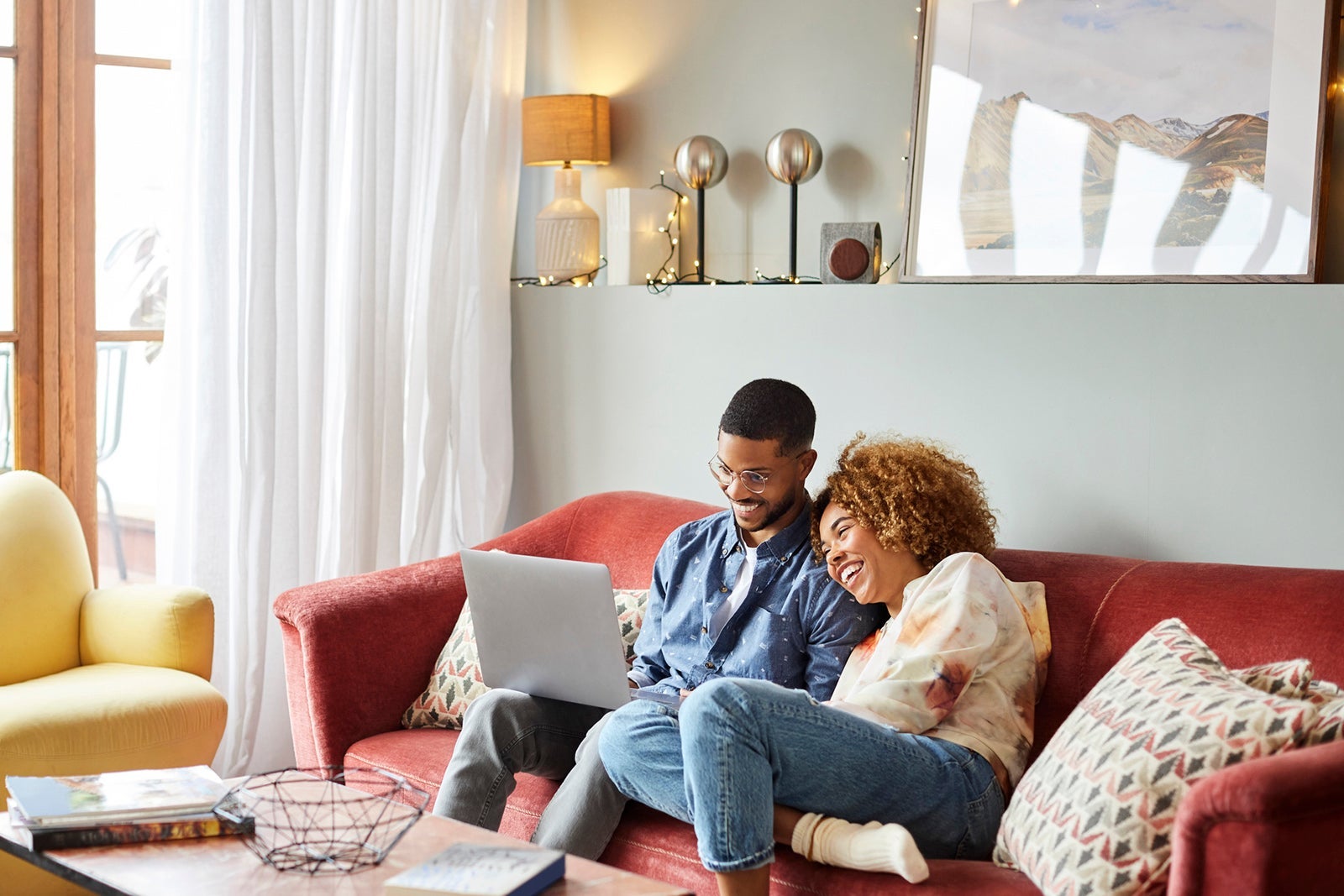 Woman Leaning On Man Using Laptop In Living Room