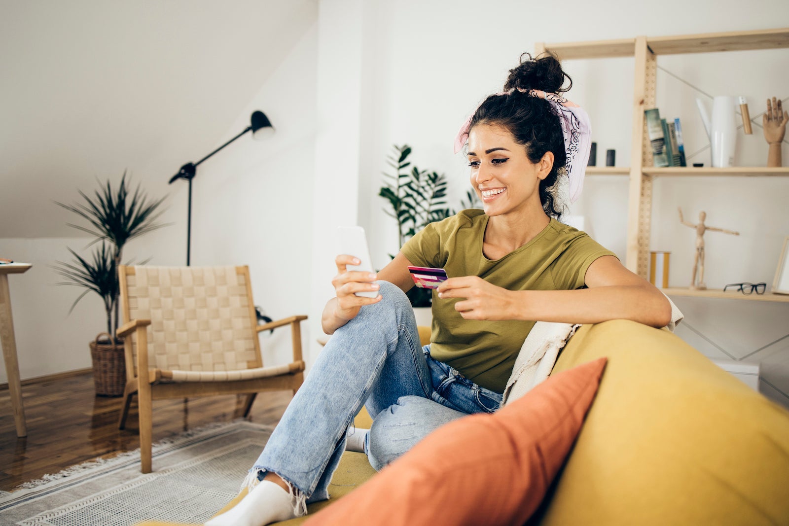 Happy girl making an online purchase at home