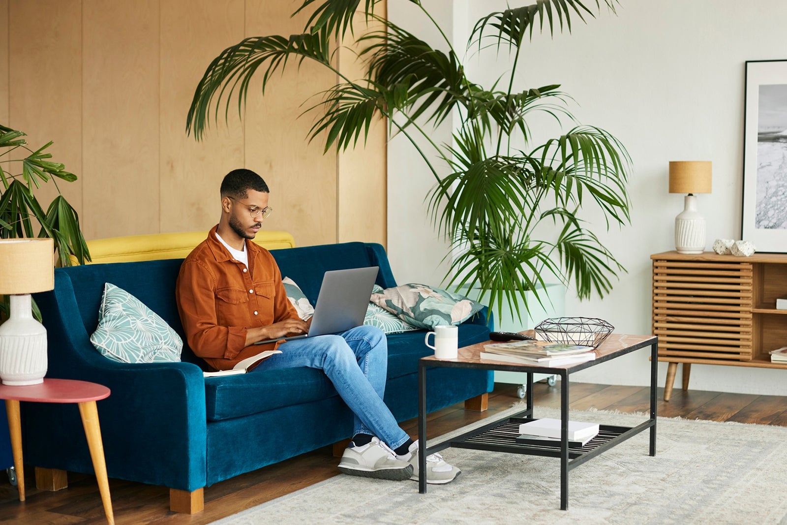 Businessman Using Laptop In Living Room At Home