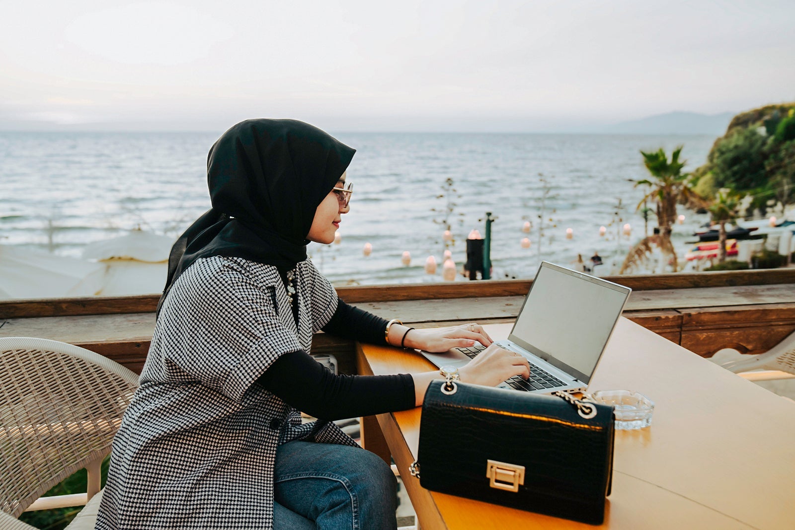 asian muslim woman working during holiday in the tourist resort