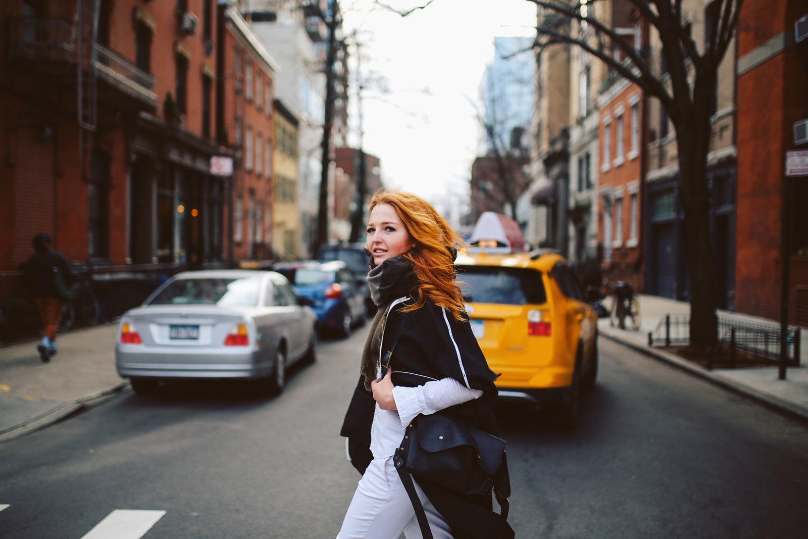 Young redhead woman walking on the streets of West Village, Manhattan, NY