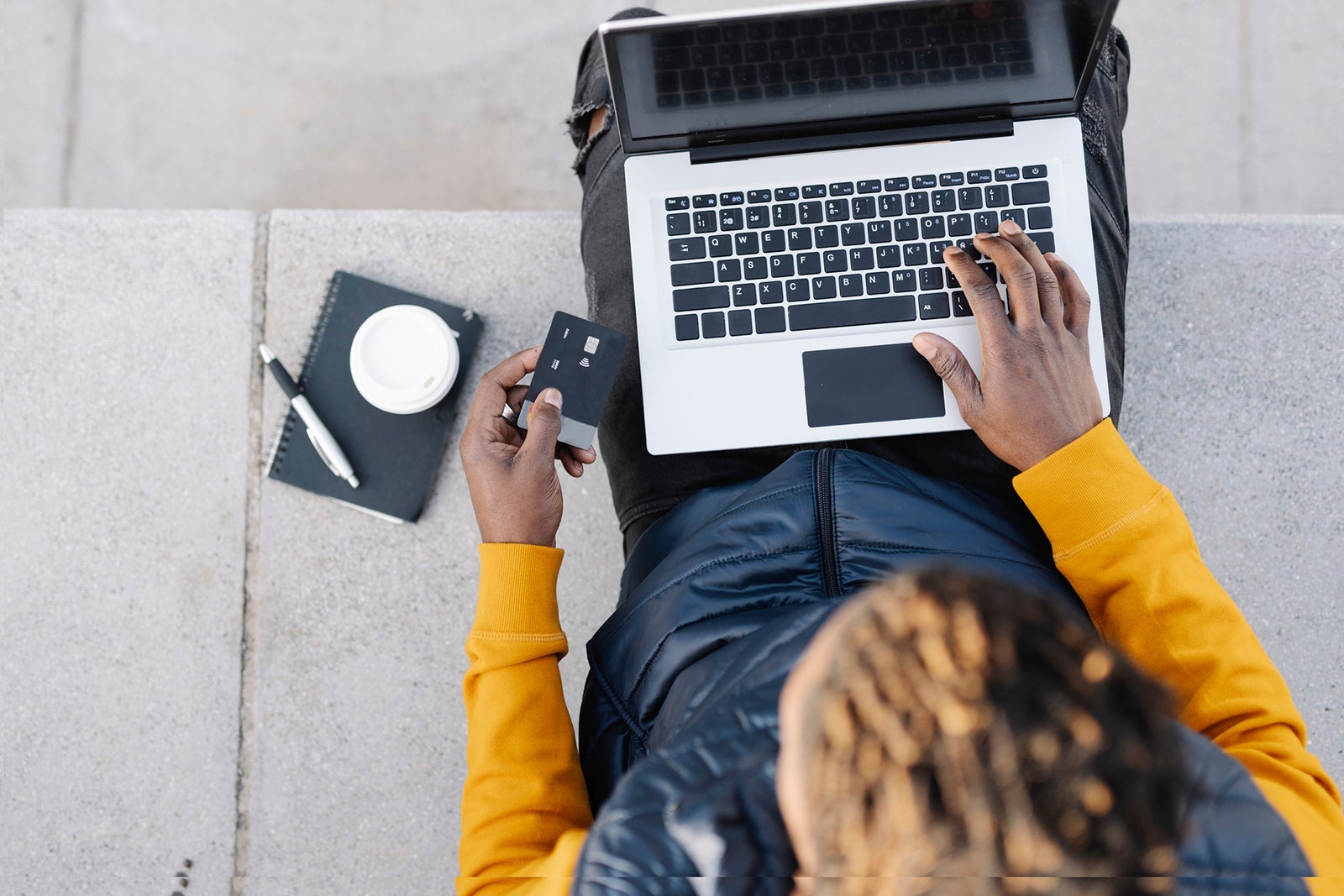 Top view of man using laptop and credit card for online shopping