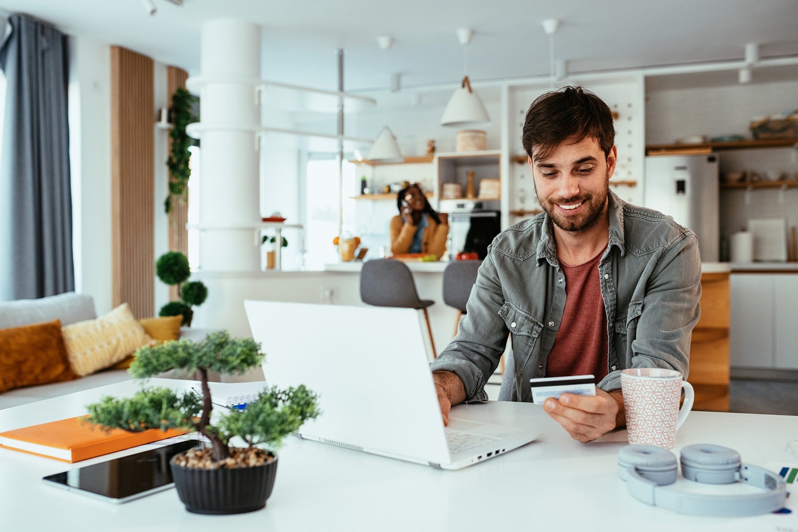 Couple at home, working on laptop