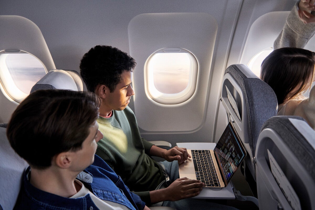 Finnair_A321_business_class_window_seat_man_looking_at_laptop_hr