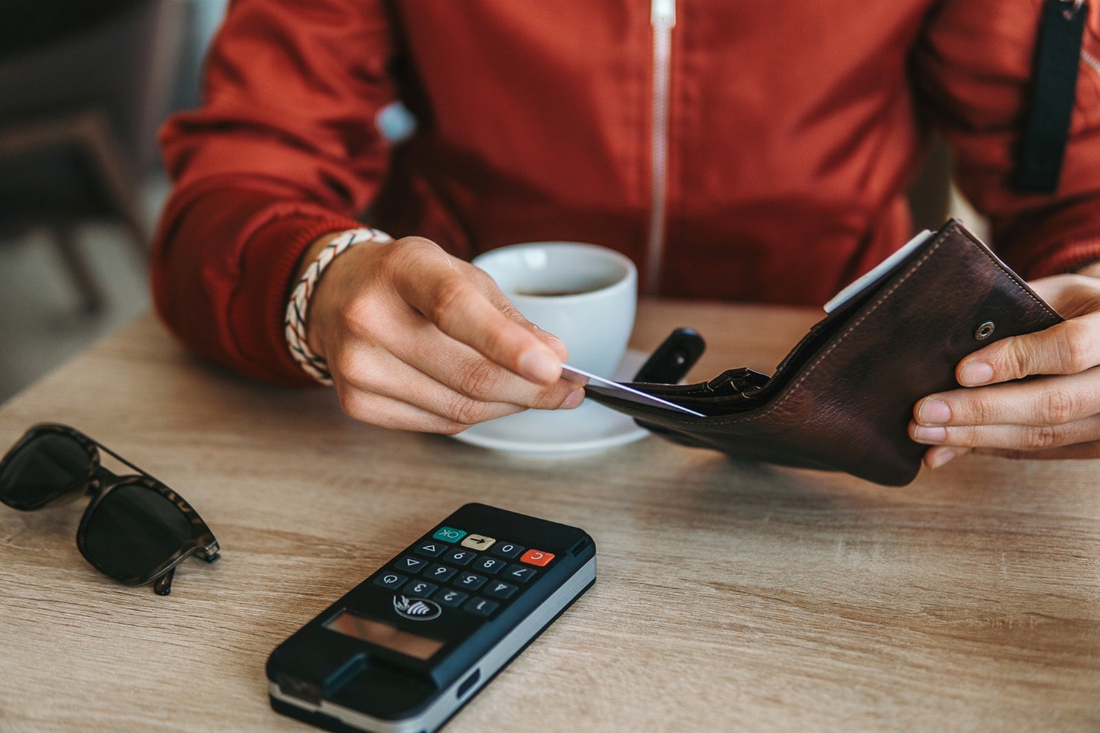 Man paying contactless in cafe