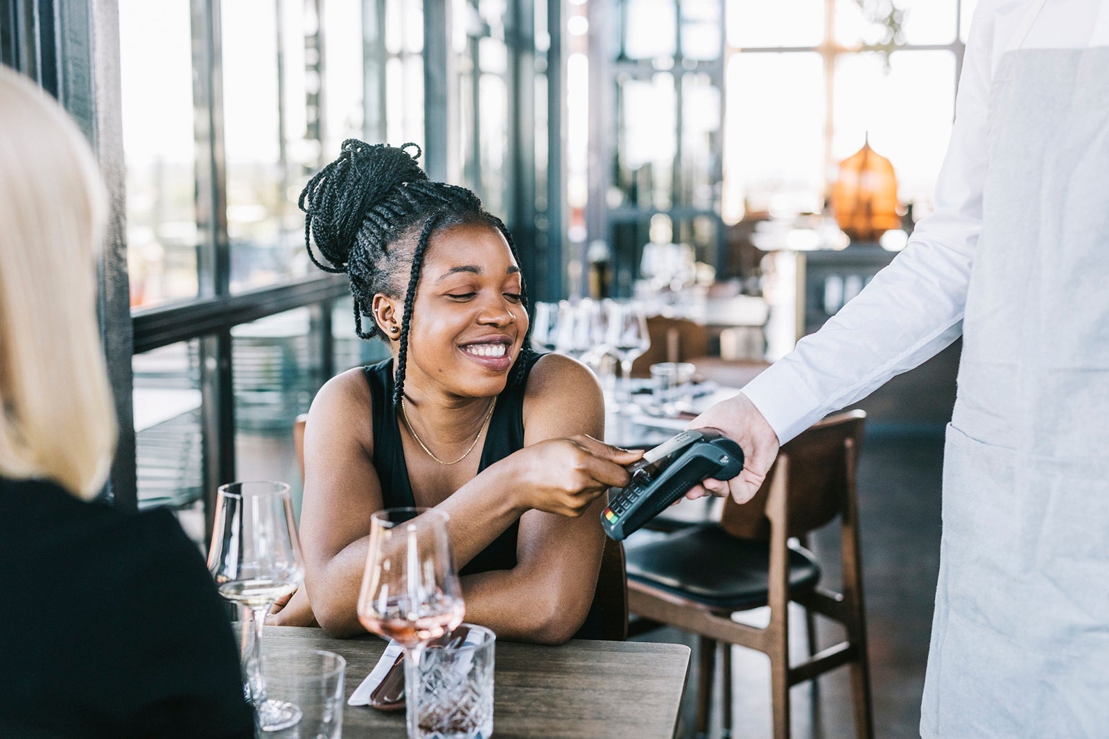 Happy African American woman using credit card