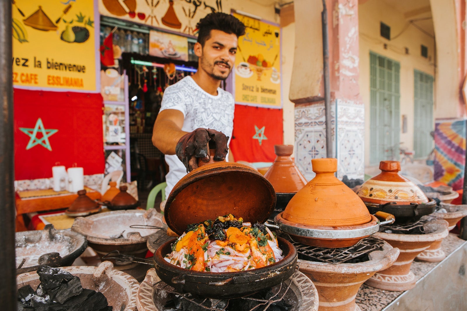 Young seller cooking vegetable tajines in Morocco.