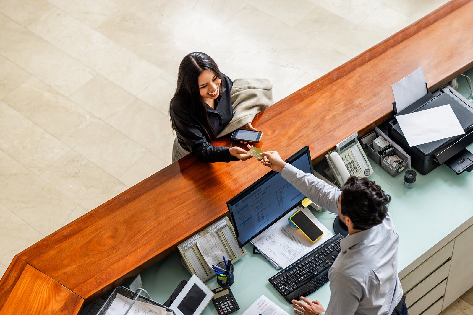 Woman traveling for business and paying by card at the hotel